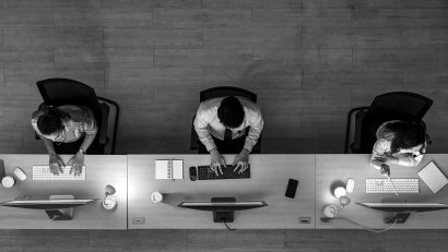 Three people seating at the desk