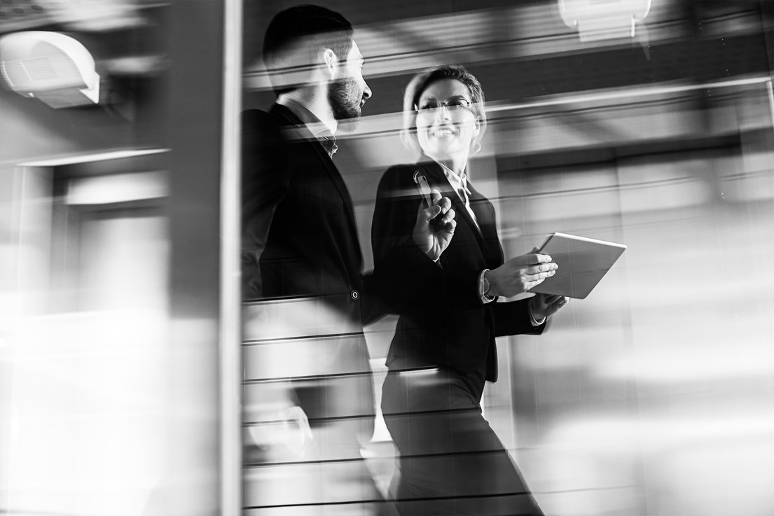 Business couple walking in the office