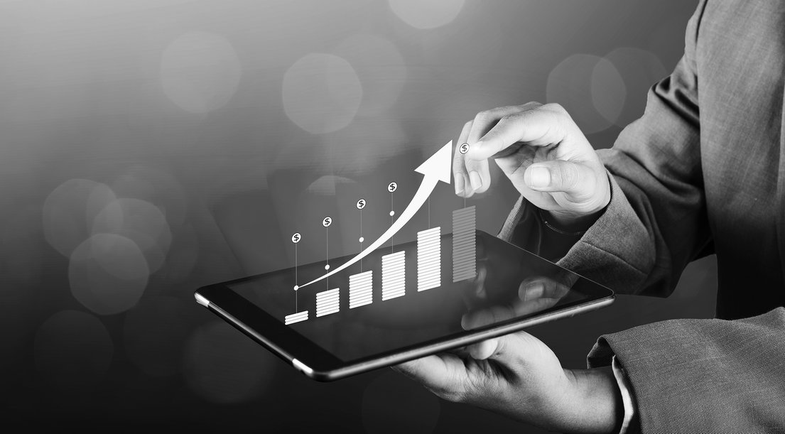 Man holding tablet with graph of financial growth
